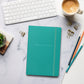 Antoine de Saint-Exupery signature turquoise notebook lifestyle